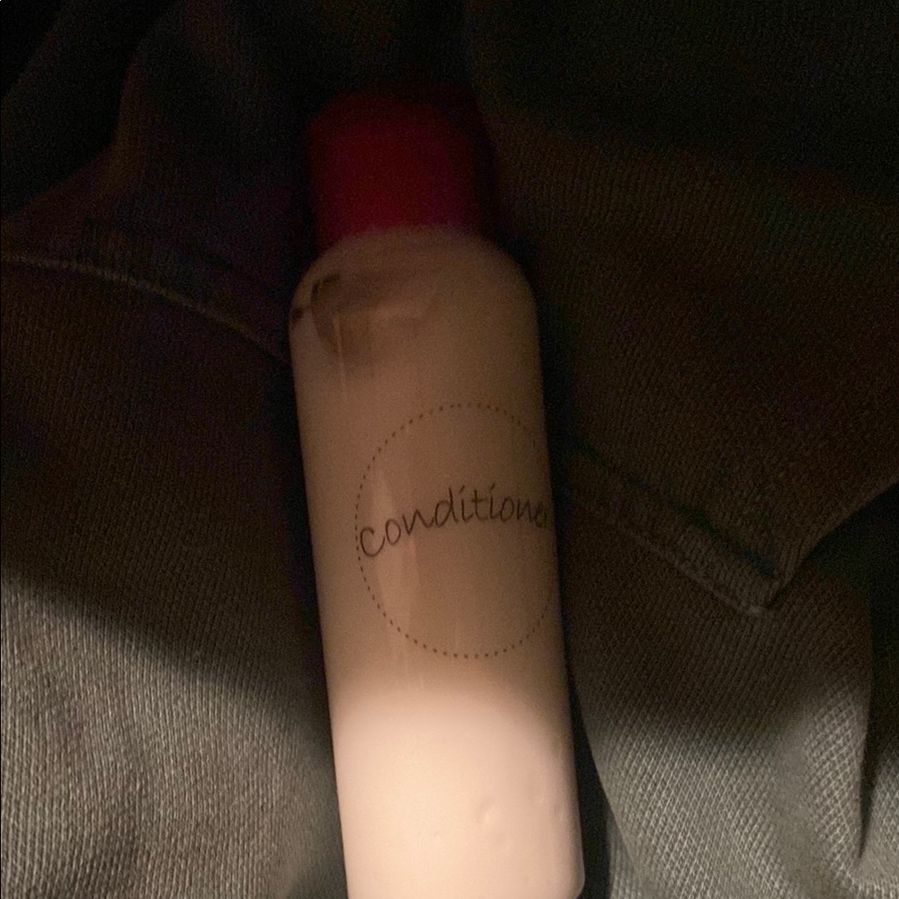 Conditioner Bottle with Red Cap smells like Roses, vanilla, and almonds.